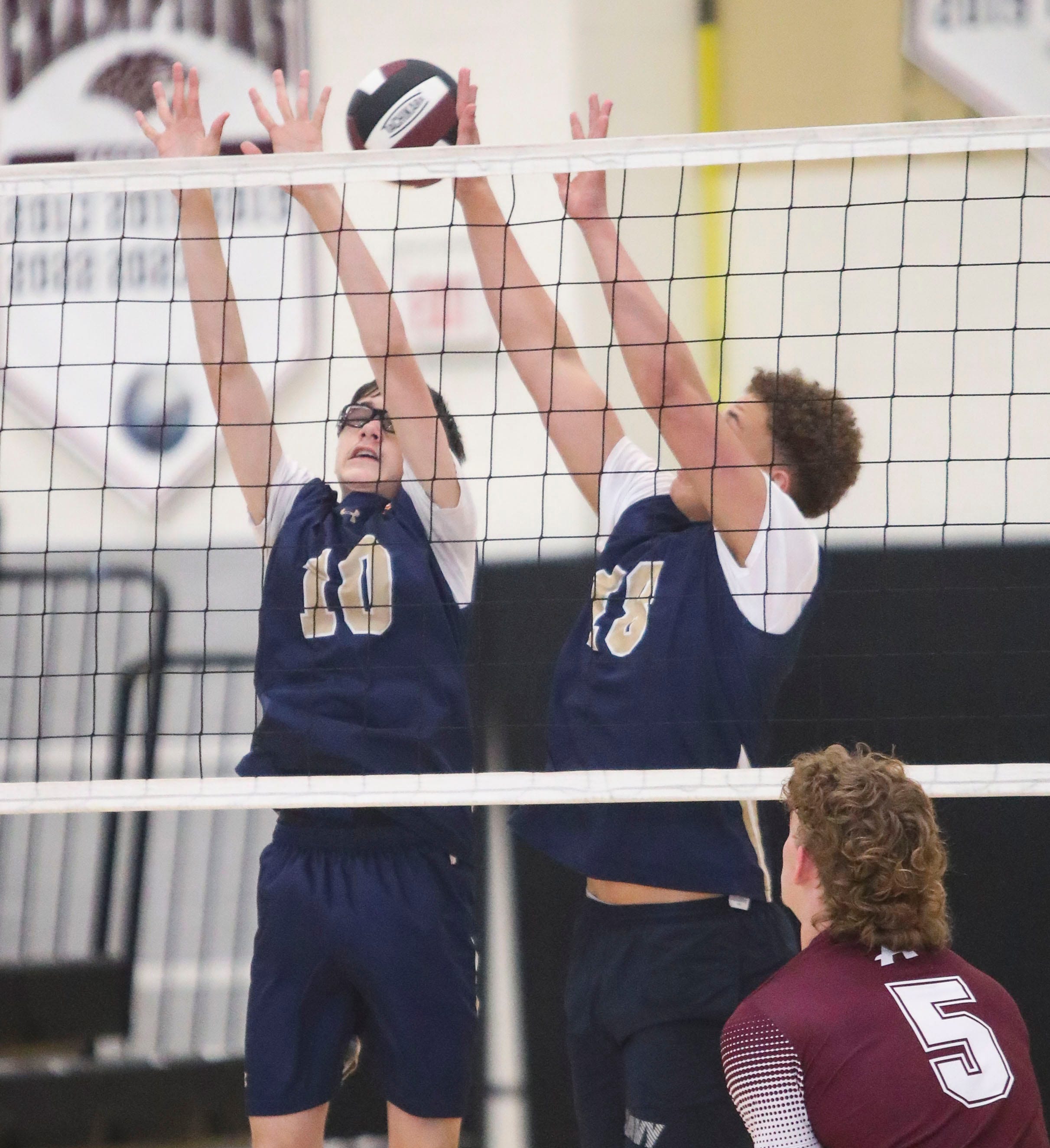 Delaware Military's Louis Lopez (10) and Braedon Graham leap to try to block a kill attempt in the Jaguars' 3-0 win at Appoquinimink, Wednesday, March 27, 2024.